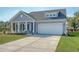 Charming home showcasing a well-manicured lawn and inviting front porch with decorative columns at 3278 Great Egret Dr, Johns Island, SC 29455