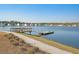 Beautiful lake view featuring a fishing pier and a walking path, perfect for outdoor recreation and relaxation at 3278 Great Egret Dr, Johns Island, SC 29455