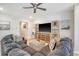 Spacious living room with a large sectional sofa, ottoman, and a stylish entertainment center at 3278 Great Egret Dr, Johns Island, SC 29455