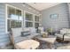 Relaxing screened-in patio with comfortable seating and string lights at 3278 Great Egret Dr, Johns Island, SC 29455