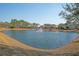 Scenic pond with a fountain, surrounded by lush greenery and beautiful neighborhood homes at 3278 Great Egret Dr, Johns Island, SC 29455