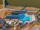 Aerial view of community pool and clubhouse, surrounded by palm trees and walking paths at 3278 Great Egret Dr, Johns Island, SC 29455