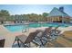Luxurious community pool with lounge chairs and a nearby pavilion, offering relaxation and entertainment at 3278 Great Egret Dr, Johns Island, SC 29455