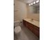 Well-lit bathroom featuring a vanity with storage, a toilet, and patterned tile flooring for a clean modern look at 330 Concord St # 4C, Charleston, SC 29401