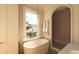 Bright bathroom featuring a soaking tub, pendant lighting, and a separate shower at 4 Trapman St # A, Charleston, SC 29401