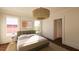 Cozy bedroom with a chandelier, hardwood floors, natural light, and neutral tones at 4 Trapman St # A, Charleston, SC 29401