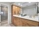 Bathroom with double sink vanity, custom cabinets, and a glass shower at 409 Yacht Harbor Ct # 409, Isle of Palms, SC 29451