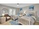 Bedroom with two beds, large window with plantation shutters, and a ceiling fan at 409 Yacht Harbor Ct # 409, Isle of Palms, SC 29451