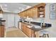 Updated kitchen featuring granite countertops, stainless steel appliances, and a cozy breakfast bar at 409 Yacht Harbor Ct # 409, Isle of Palms, SC 29451