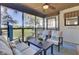 Comfortable screened porch with ample seating, greenery, and views of the outdoors at 409 Yacht Harbor Ct # 409, Isle of Palms, SC 29451