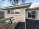 Brick home featuring a backyard patio with a wooden bench and sliding glass doors at 4341 Helene Dr, North Charleston, SC 29418