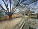 Spacious backyard featuring a large tree, wood fence, small shed, and an upper deck at 4341 Helene Dr, North Charleston, SC 29418
