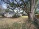 Large tree shading a home with a spacious backyard and an upper deck at 4341 Helene Dr, North Charleston, SC 29418