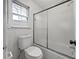 Bright bathroom featuring a white toilet, bathtub, and shower with sliding doors at 4341 Helene Dr, North Charleston, SC 29418