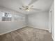 Bright, neutral bedroom with carpet, two windows, and a ceiling fan for a comfortable and airy feel at 4341 Helene Dr, North Charleston, SC 29418