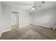 Spacious, carpeted bedroom featuring a ceiling fan and an open doorway leading to the bathroom at 4341 Helene Dr, North Charleston, SC 29418