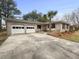 Charming brick home with a well-maintained lawn, mature trees and a two-car garage at 4341 Helene Dr, North Charleston, SC 29418