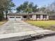Charming brick home with a well-maintained lawn, mature trees and a two-car garage at 4341 Helene Dr, North Charleston, SC 29418