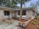Charming home with a well-manicured lawn, mature trees, and a welcoming entrance at 4341 Helene Dr, North Charleston, SC 29418