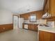 Spacious kitchen with wood cabinets, white appliances, and a window for natural light at 4341 Helene Dr, North Charleston, SC 29418