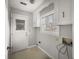 Bright laundry room with white walls, a utility sink, and a window overlooking the backyard at 4341 Helene Dr, North Charleston, SC 29418