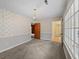 Living room with neutral carpet, wallpaper, and a decorative chandelier at 4341 Helene Dr, North Charleston, SC 29418