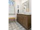 Bathroom featuring custom vanity, patterned tile floor, and natural light at 493 Woodland Shores Rd, Charleston, SC 29412