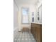 Bright bathroom with custom vanity, shower-tub, and decorative patterned floor at 493 Woodland Shores Rd, Charleston, SC 29412