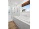Spa bathroom with glass shower and soaking tub, bright light from the window and white subway tiles at 493 Woodland Shores Rd, Charleston, SC 29412
