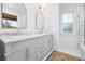Elegant bathroom with double vanity featuring marble countertop, arched mirrors, and stylish lighting at 493 Woodland Shores Rd, Charleston, SC 29412