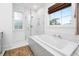 Bright bathroom featuring a soaking tub with a marble surround and a glass-enclosed shower at 493 Woodland Shores Rd, Charleston, SC 29412