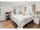 Bright bedroom with natural light, neutral paint, and light colored wood flooring at 493 Woodland Shores Rd, Charleston, SC 29412