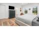 Bedroom showcasing a dresser with TV and view to the bathroom with natural light from the window at 493 Woodland Shores Rd, Charleston, SC 29412