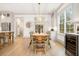 Well-lit dining room featuring hardwood floors, a modern chandelier, and backyard access at 493 Woodland Shores Rd, Charleston, SC 29412