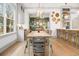 Elegant dining room featuring stylish light fixture, wood table, and view to living room and kitchen at 493 Woodland Shores Rd, Charleston, SC 29412