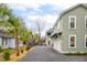 Beautifully landscaped exterior with a driveway and palm trees, adding curb appeal at 493 Woodland Shores Rd, Charleston, SC 29412