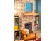 Fireplace featuring a brick surround, wooden mantel, and built-in bookshelves at 493 Woodland Shores Rd, Charleston, SC 29412
