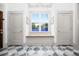 Elegant foyer featuring a large window with bench seating and stylish tile floors at 493 Woodland Shores Rd, Charleston, SC 29412