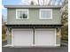 Two car garage with overhead apartment and white garage doors at 493 Woodland Shores Rd, Charleston, SC 29412