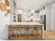 Open kitchen featuring a marble island with bar seating and view of chef-style oven and stainless steel fridge at 493 Woodland Shores Rd, Charleston, SC 29412