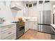 Contemporary kitchen featuring stainless steel fridge, tile backsplash, and chef-style oven with range hood at 493 Woodland Shores Rd, Charleston, SC 29412