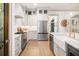 Fully-equipped kitchen with stainless steel fridge, farmhouse sink, and chef-style range with white cabinets at 493 Woodland Shores Rd, Charleston, SC 29412