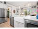 Kitchen with marble island featuring modern lighting and farmhouse sink with view to dining area at 493 Woodland Shores Rd, Charleston, SC 29412