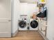 Functional laundry room featuring modern washer and dryer with a wall-mounted storage unit at 493 Woodland Shores Rd, Charleston, SC 29412
