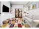 Playful living room with colorful rug, wall mounted TV, and light gray sectional sofa at 493 Woodland Shores Rd, Charleston, SC 29412