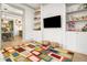 living room with colorful rug, wall mounted TV, and view into kitchen and dining area at 493 Woodland Shores Rd, Charleston, SC 29412