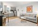 Open-concept living space with a modern sofa and adjacent kitchen area at 493 Woodland Shores Rd, Charleston, SC 29412