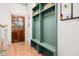 Mudroom featuring a wooden door, wood floors, and built-in green lockers with hooks and storage at 493 Woodland Shores Rd, Charleston, SC 29412