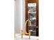 Close-up of a vintage brass sink and faucet with stained glass door in the background at 493 Woodland Shores Rd, Charleston, SC 29412