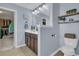 Well-lit bathroom featuring a dark wood vanity, framed mirror and decorative shelves at 5073 Blair Rd, Summerville, SC 29483